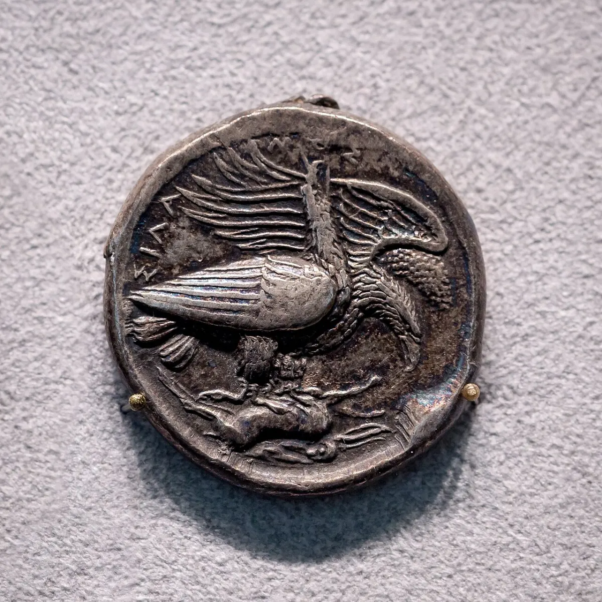 A silver coin: two eagles stand over a dead hare, one with wings spread.