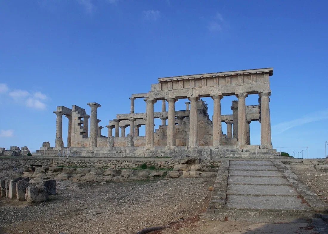 A Doric temple on a rise, its columns standing against a blue sky.