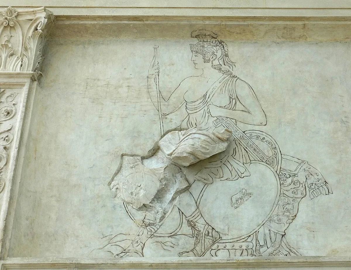 A marble panel with a seated goddess in a helmet, resting on a pile of weapons, partly restored in outline.