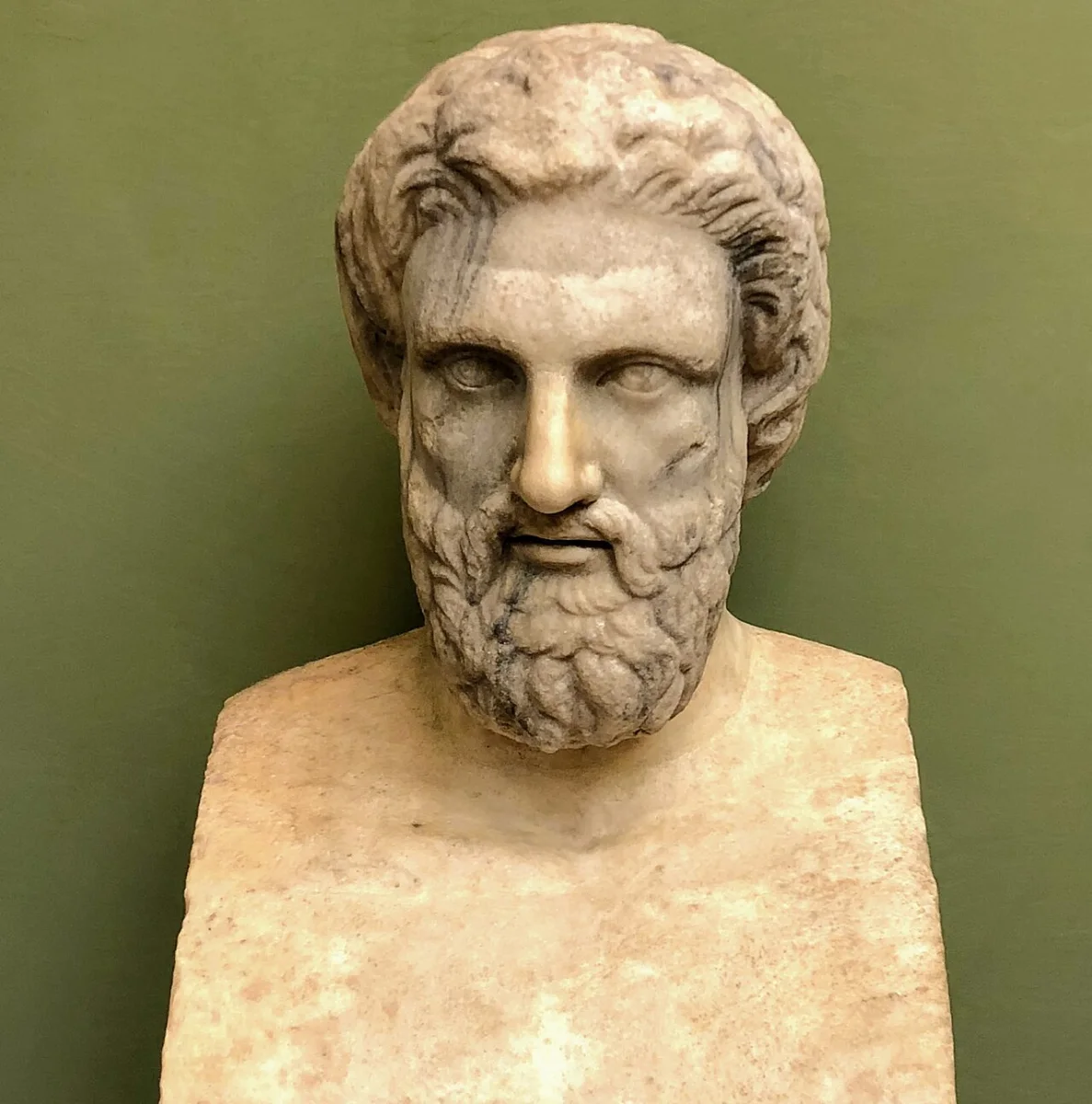 Marble portrait head of a bearded man with thick wavy hair, set on a herm.
