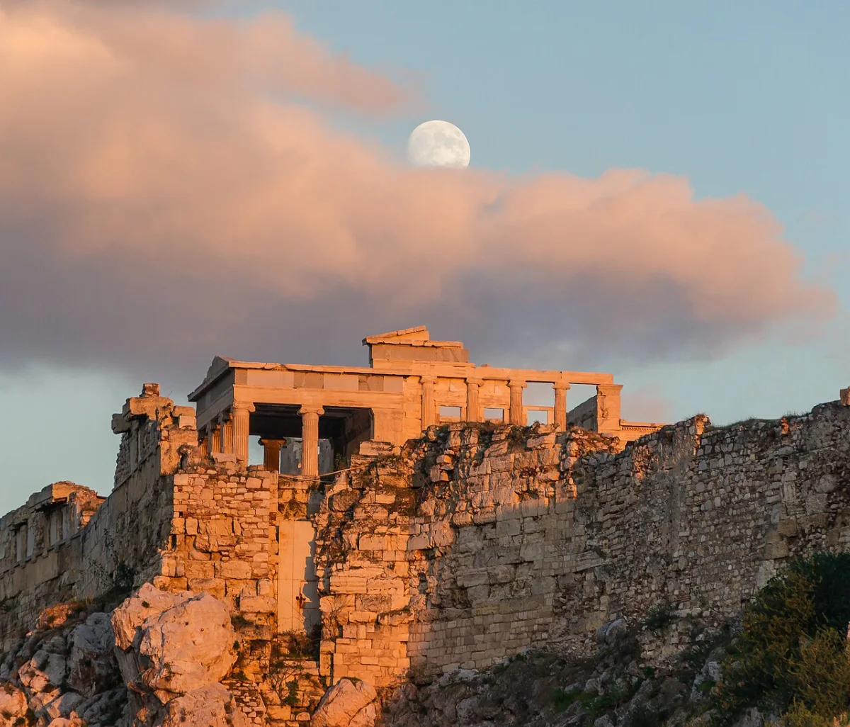The Erechtheum on the Acropolis rock in evening light, the moon above.