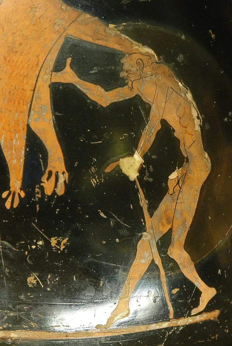 A red-figure detail: a bent, shrivelled old man leaning on a stick.