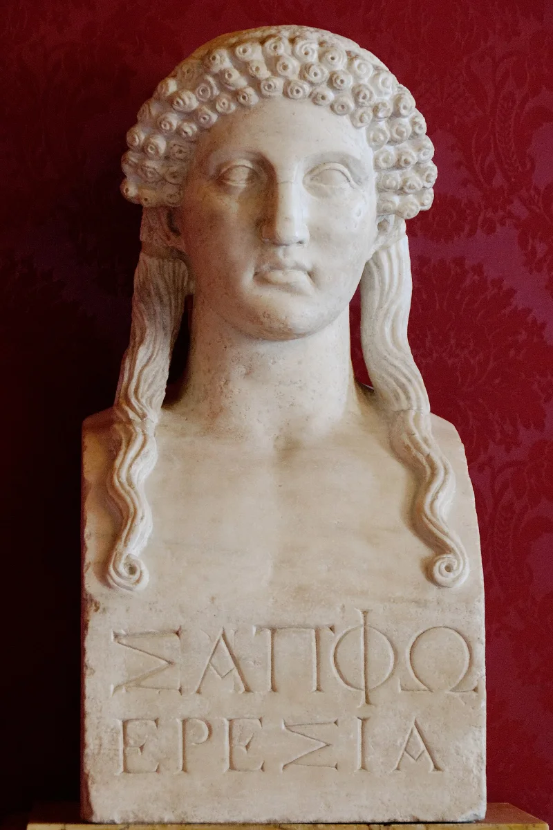 A Roman marble herm of a woman with curled hair, inscribed below ΣΑΠΦΩ ΕΡΕΣΙΑ.